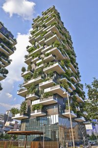 Bosco Verticale (Vertical Forest)，米兰，Boeri Studios (2009-2014);蔓生的塔楼与蔓生的绿色植物相遇。一个大的建筑，花不均匀，在这些不均匀的平台上生长着各种植物。