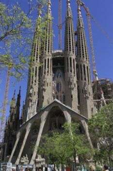 Sagrada Familia, Gaudì, 1882-1926, Barcelona: a large, pointy structure with four distinct towers.